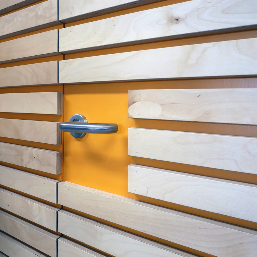 Detail of a steel door handle on a crenellated wooden door