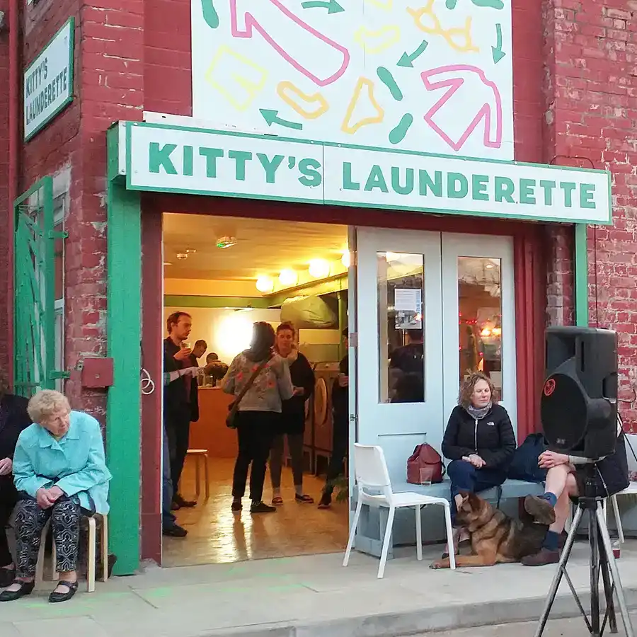 Music event outside launderette with fiddle player