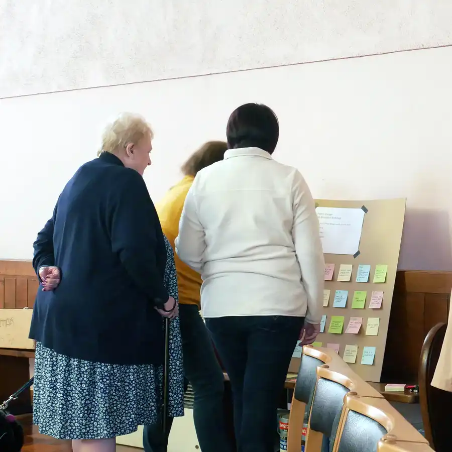 Workshop group with cork pin boards submitting ideas